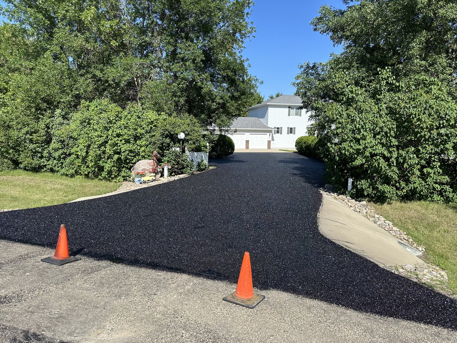 Residential driveway after fresh asphalt paving